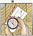 Hacer girar la cápsula hasta que la 'N' del limbo señale el norte magnético en el mapa.